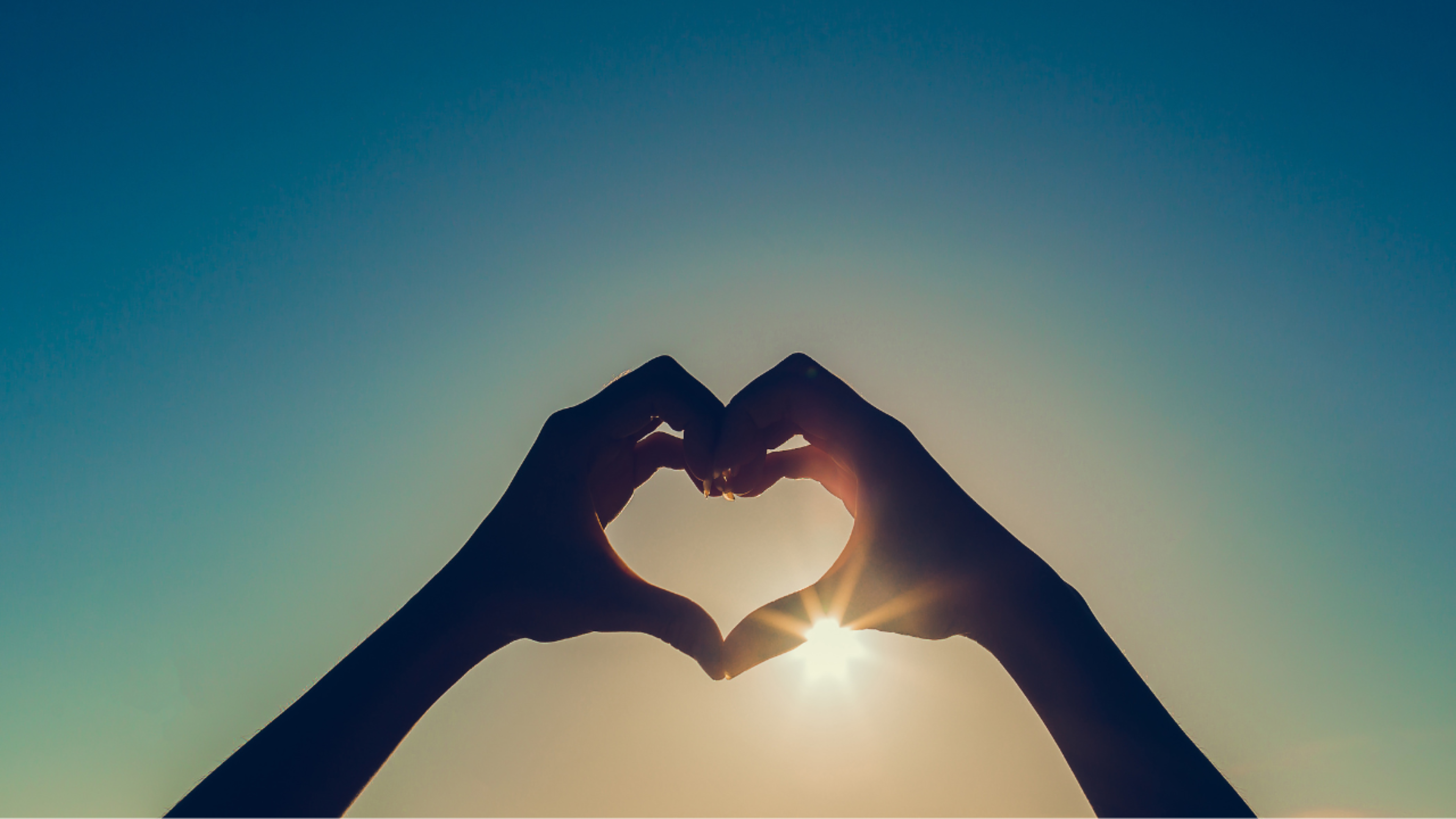 Hands forming a heart shape in sunlight, symbolising appreciation and positive treatment experiences.